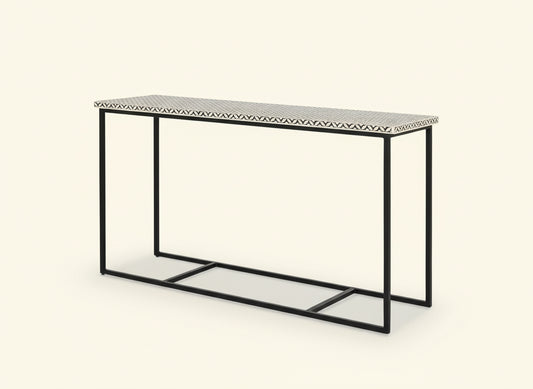 Console table with black metal frame and patterned top on a white background