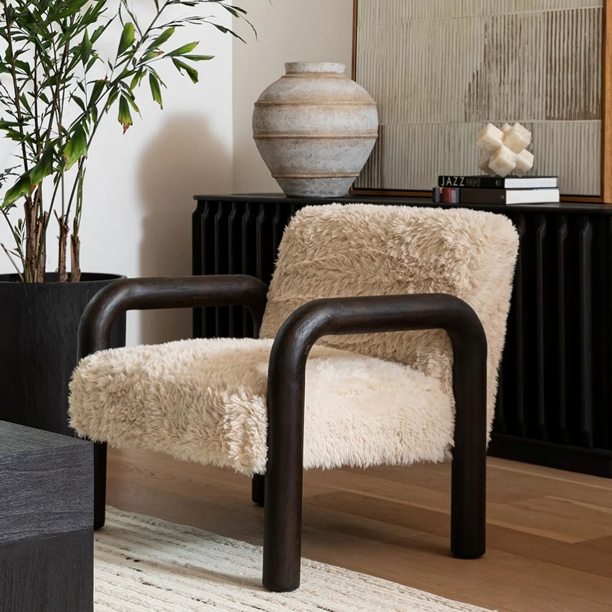 Chair with fluffy beige cushion and wooden frame