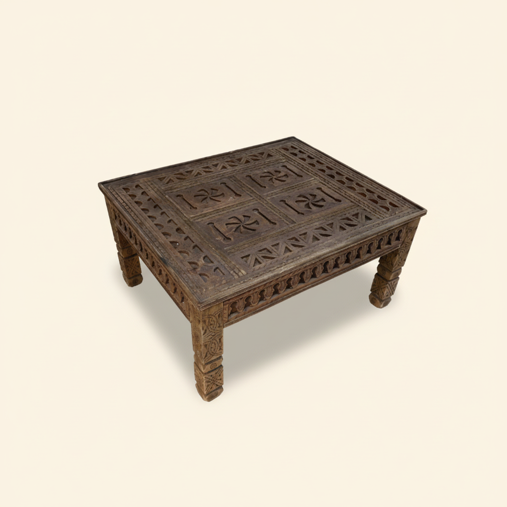 Wooden coffee table with intricate carvings on a white background